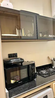 a microwave sitting on top of a kitchen counter at Functional and Stylish Apartment in Agdal for Rabat Stay in Rabat