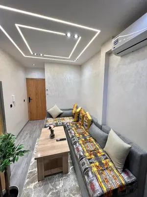 a living room with a couch and a table at Functional and Stylish Apartment in Agdal for Rabat Stay in Rabat