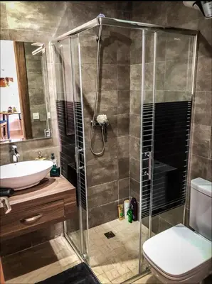 a bathroom with a shower and a toilet and a sink at Tranquil in Casablanca