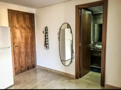 a mirror on a wall next to a bathroom at Tranquil in Casablanca