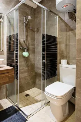 a bathroom with a shower with a toilet and a sink at Tranquil in Casablanca
