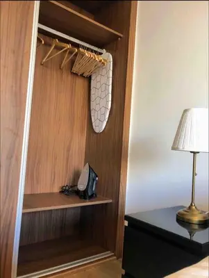 a room with a closet with a lamp on a table at Tranquil in Casablanca