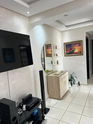 a living room with a tv on a wall at Luxueux appartement très chic le bienvenue in Rabat