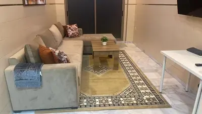 a living room with a couch and a coffee table at The Park Apartment in Mohammedia
