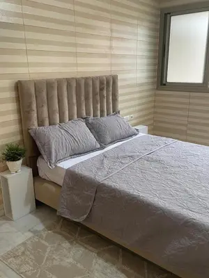 a bedroom with a large bed with a large headboard at The Park Apartment in Mohammedia