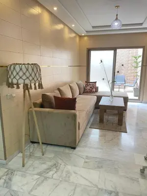 a living room with a couch and a table at The Park Apartment in Mohammedia