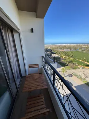 a balcony with a view of the ocean at Évasion zen près de Casablanca - Vue imprenable sur le parc et la plage de l'Éco City Zenata in Aïn Harrouda