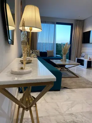 a living room with a couch and a table at Quartier l oasis prêt de la gare in Casablanca