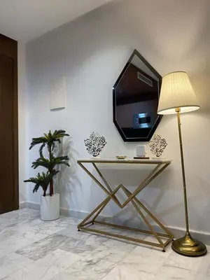 a tv on a wall with a table with a lamp at Quartier l oasis prêt de la gare in Casablanca