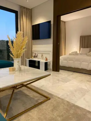 a bedroom with a bed and a tv on the wall at Quartier l oasis prêt de la gare in Casablanca