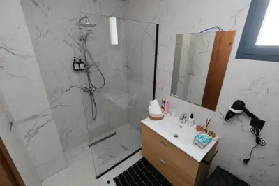 a bathroom with a shower and a sink with a mirror at Appartement chic et cosy - Casablanca Finance City in Casablanca