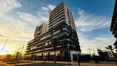 a tall building with people standing in front of it at Appartement chic et cosy - Casablanca Finance City in Casablanca