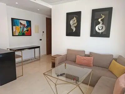 a living room with a couch and a table at Signature Leving 119 in Casablanca