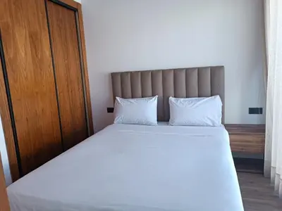 a bedroom with a large bed with white sheets and pillows at Signature Leving 119 in Casablanca
