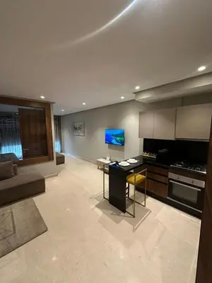 a large living room with a television and a kitchen at Signature Leving 119 in Casablanca