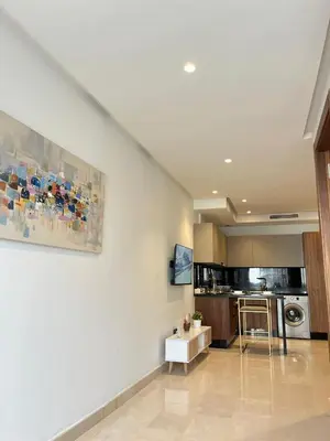 a large living room with a kitchen and a painting at Signature Leving 119 in Casablanca