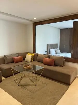 a living room with a couch and a glass table at Signature Leving 119 in Casablanca