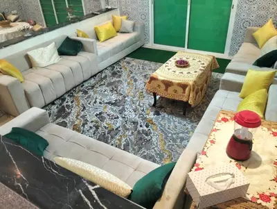 a living room with a couch and a table at RiadNA bouznika in Bouznika