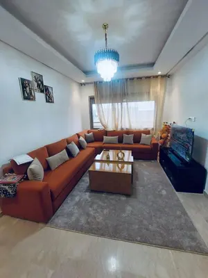 a living room with a couch and a coffee table at Séjour serein près aéroport in Nouaceur