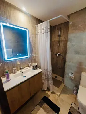 a bathroom with a sink and a shower and a toilet at Séjour serein près aéroport in Nouaceur