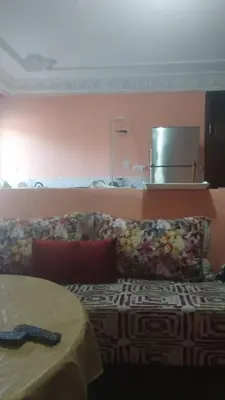 a bed in a room with a couch and a table at Old school in Rabat
