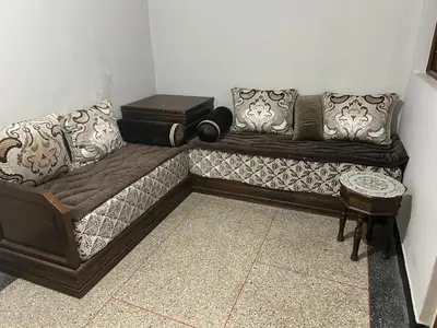 a couch with pillows on it in a room at Old school in Rabat