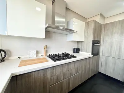 a kitchen with white cabinets and a stove at Luxury apartment Marina in Casablanca