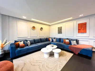 a living room with a blue couch and a table at Luxury apartment Marina in Casablanca