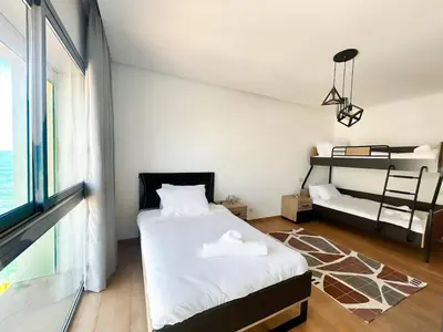 a bedroom with a bed and a view of the ocean at 2-bedroom apartment with a breathtaking sea view in Casablanca