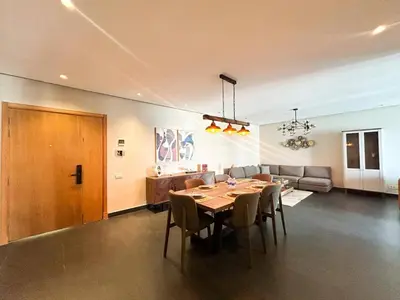 a dining room with a table and chairs and a couch at 2-bedroom apartment with a breathtaking sea view in Casablanca