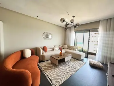 a living room with a couch and a table at 2-bedroom apartment with a breathtaking sea view in Casablanca