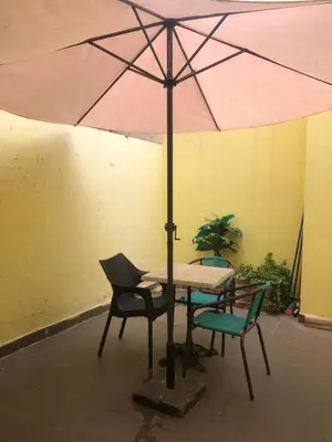 a table and chairs with a pink umbrella at Bea & dozo in Casablanca
