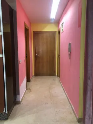 a hallway with pink and yellow walls and a door at Bea & dozo in Casablanca