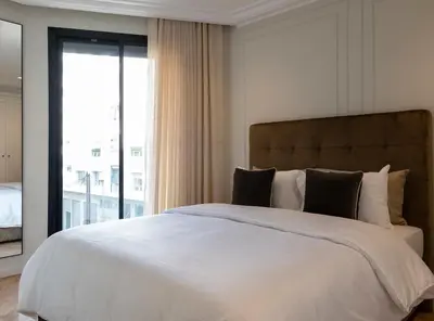 a bedroom with a large bed with a large window at Cozy & Modern Apartment with Rooftop Gym Great Casablanca Location in Casablanca