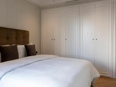 a bedroom with a large white bed and white cabinets at Cozy & Modern Apartment with Rooftop Gym Great Casablanca Location in Casablanca