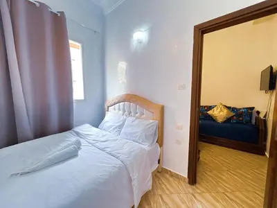 a bedroom with a white bed and a mirror at Center Cozy Home in Casablanca