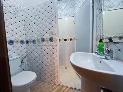 a bathroom with a toilet and a sink and a shower at Center Cozy Home in Casablanca