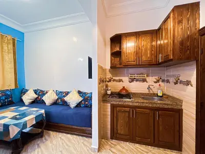 a living room with a blue couch and a sink at Center Cozy Home in Casablanca