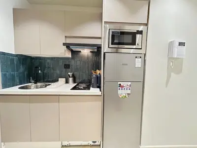 a kitchen with a refrigerator and a sink at Chic & Design Loft À 5 Minutes de la Corniche in Casablanca