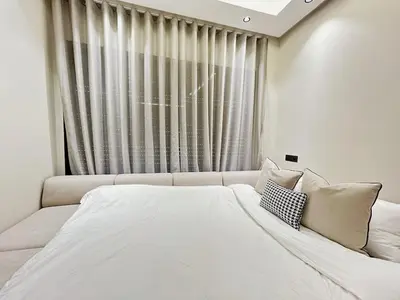 a large white bed in a room with a window at Chic & Design Loft À 5 Minutes de la Corniche in Casablanca