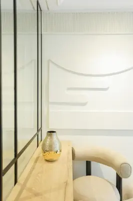 a vase sitting on a table next to a chair at Cosy cocon Racine in Casablanca