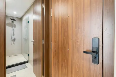 a wooden door in a bathroom with a shower at Superb apartment Casa Bourgogne - parking in Casablanca