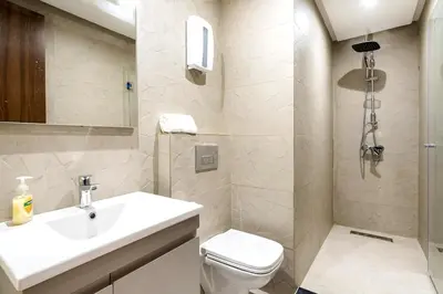 a white bathroom with a sink and a toilet at Superb apartment Casa Bourgogne - parking in Casablanca