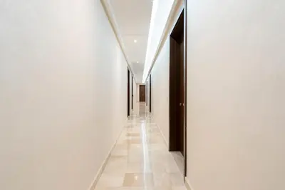 a hallway of a building with white walls and a tile floor at Superb apartment Casa Bourgogne - parking in Casablanca