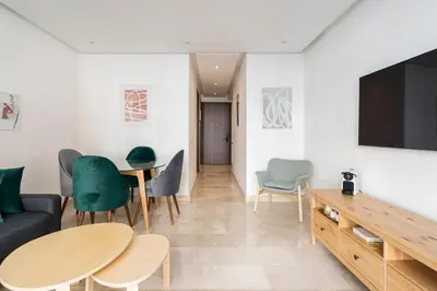 a living room with a couch and a table and chairs at Superb apartment Casa Bourgogne - parking in Casablanca