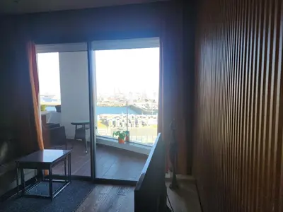 a room with a large window with a view of the city at test chanel in Casablanca