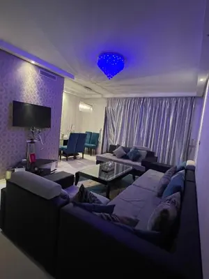 a living room with a couch and a tv at Beachside Charming Apartment in Tamaris