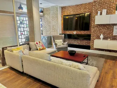 a living room with two couches and a tv at Charming 3 Bedroom Apt in Agdal in Rabat