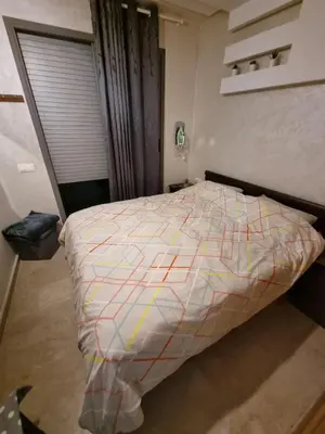 a bedroom with a bed with a colorful comforter at Heart of Casablanca - Tramway in Casablanca