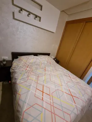 a bed with a colorful comforter in a bedroom at Heart of Casablanca - Tramway in Casablanca